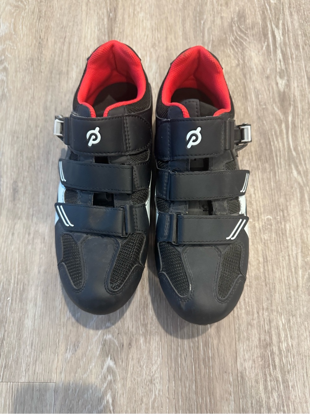 Peloton cycling shoes w/ red inner lining & triple-hook-and-loop strap closure